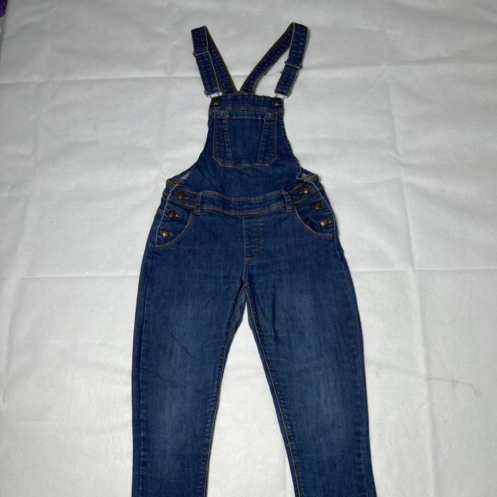 Dark wash denim overalls with adjustable straps and pockets